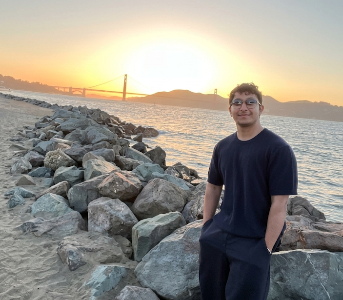 Ashwat Rajbhandari, Founding Engineer at ASU SUN, standing beside San Francisco Bay